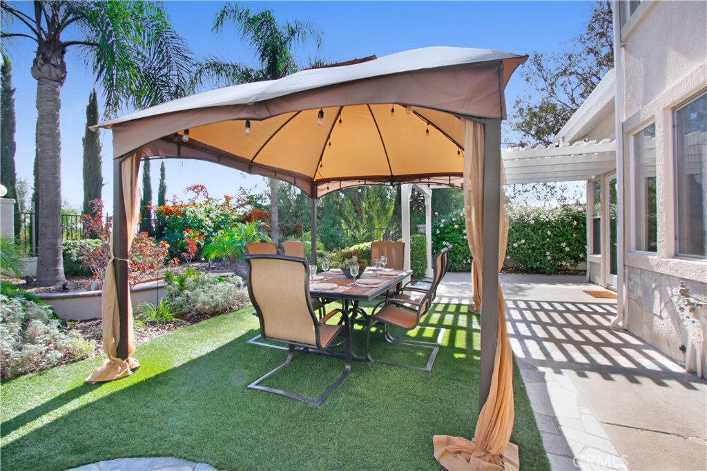 12036 Wood Ranch Road Granada Hills, CA 91344 - Photo 47 of 55 Gazebo with patio seating and string lighting.