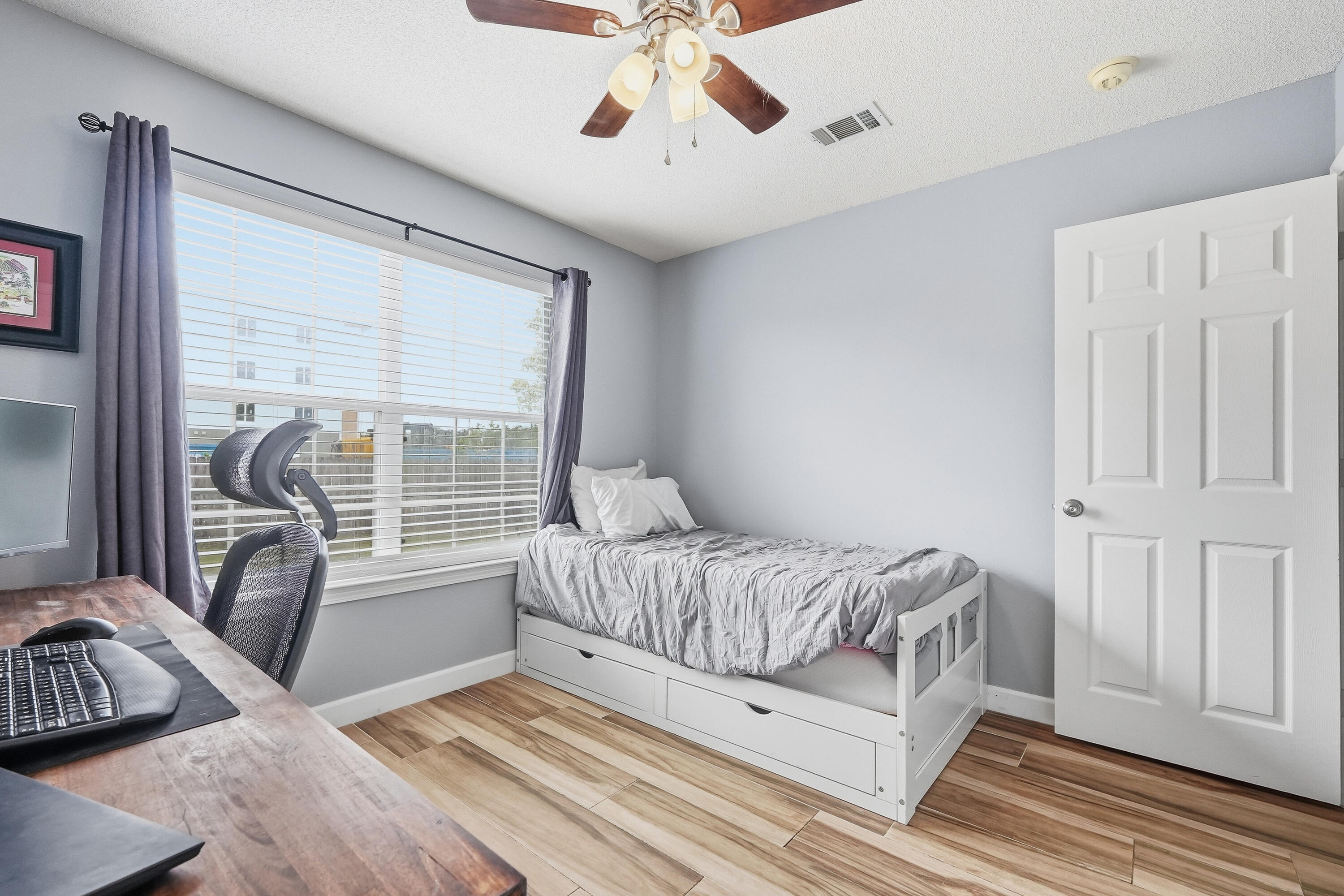 766 Randall Roberts Road Fort Walton Beach, FL 32547 - Photo 19 of 41 a living room with a bed furniture and a large window