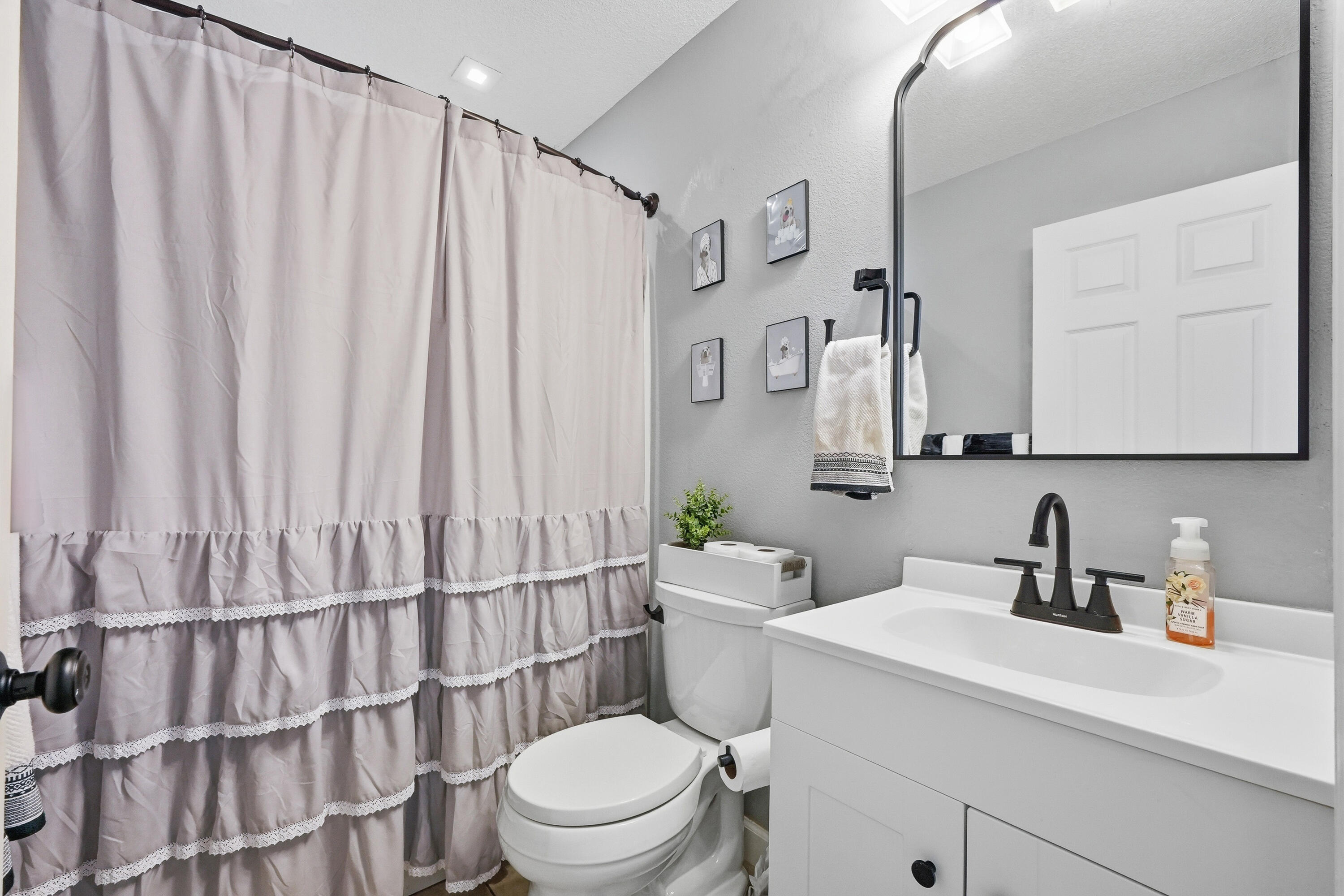 766 Randall Roberts Road Fort Walton Beach, FL 32547 - Photo 20 of 41 a bathroom with a toilet a sink and a mirror