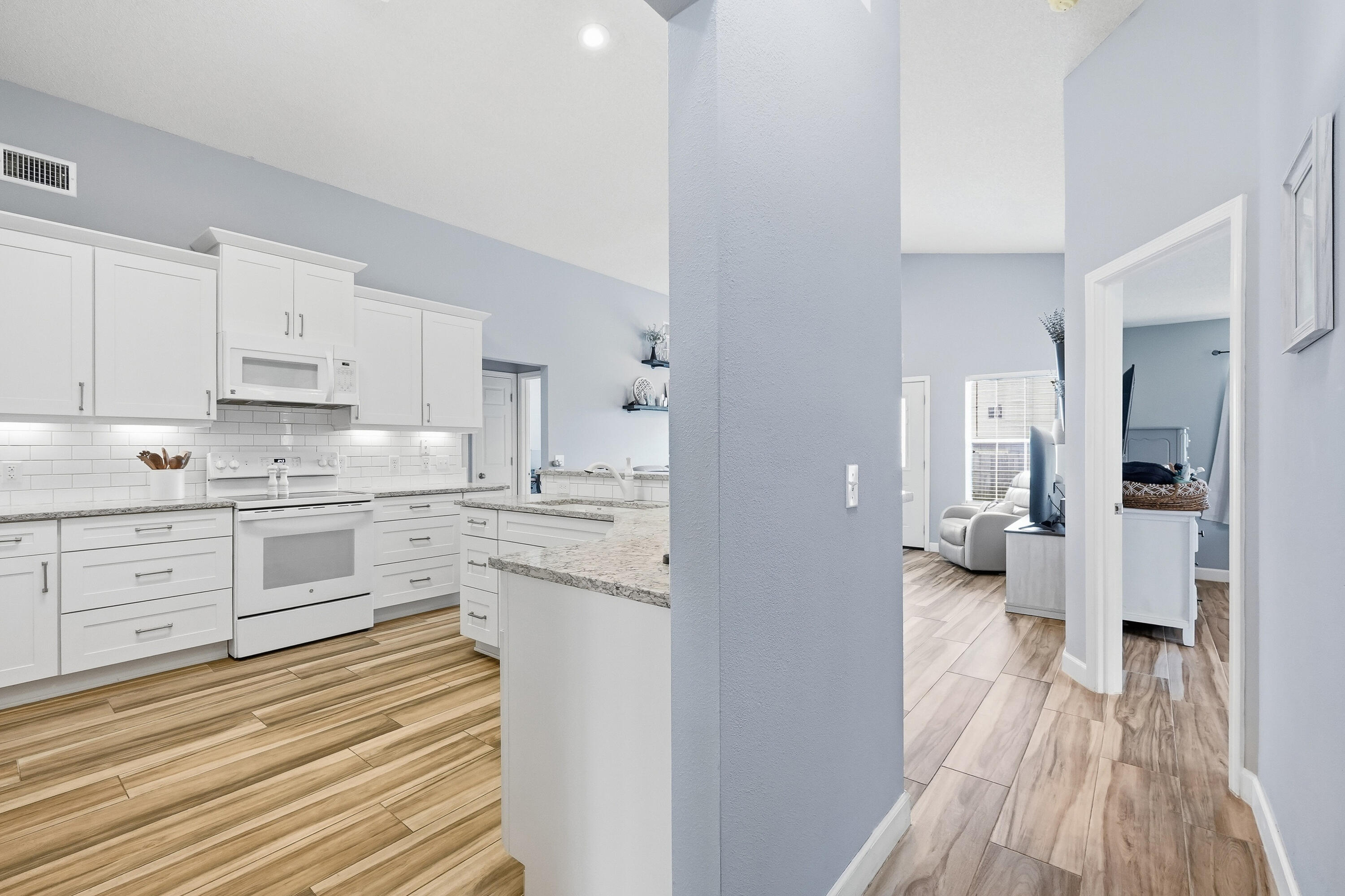 766 Randall Roberts Road Fort Walton Beach, FL 32547 - Photo 26 of 41 a kitchen with white cabinets and stainless steel appliances
