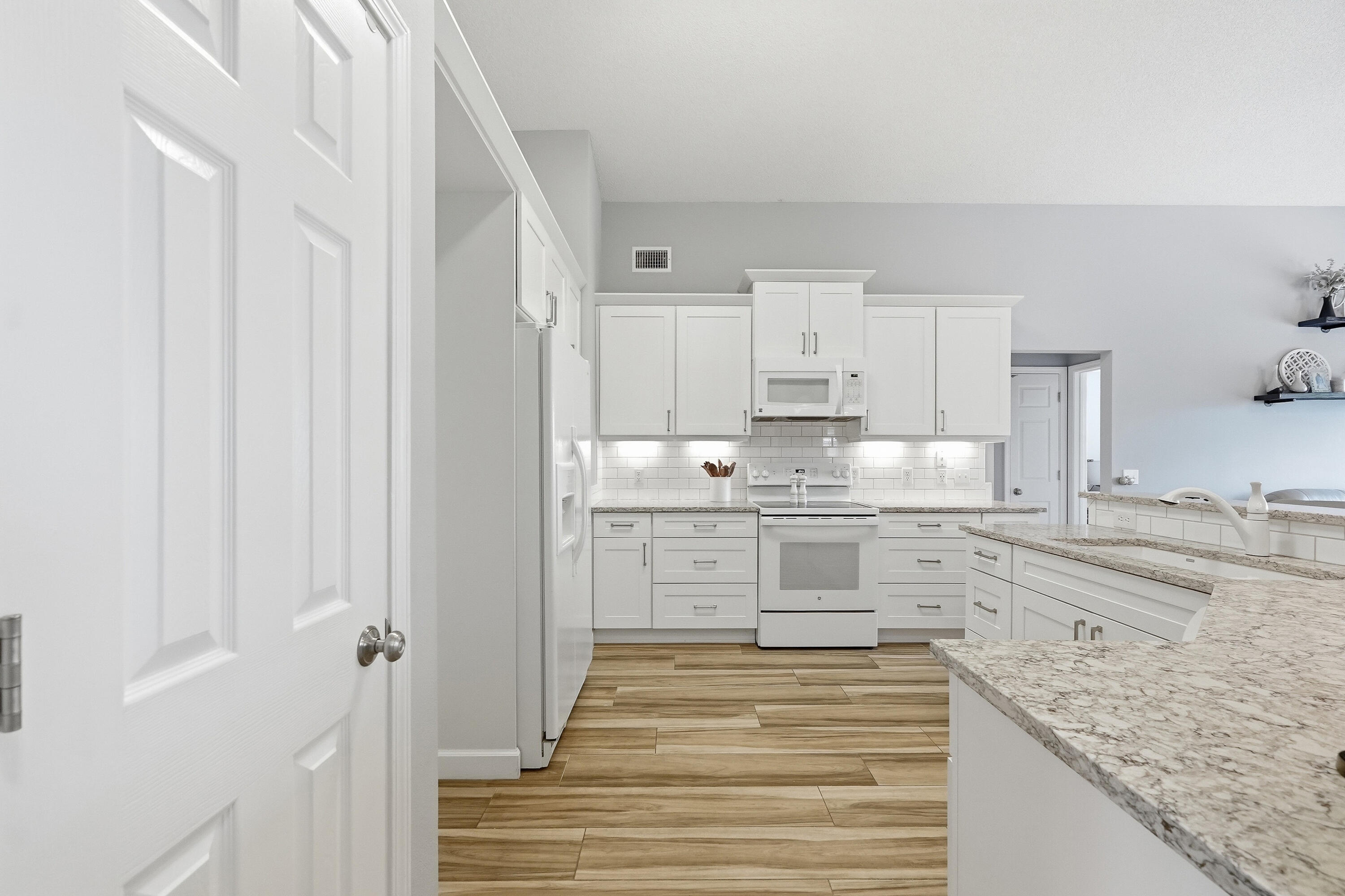 766 Randall Roberts Road Fort Walton Beach, FL 32547 - Photo 27 of 41 a kitchen with granite countertop white cabinets and white appliances