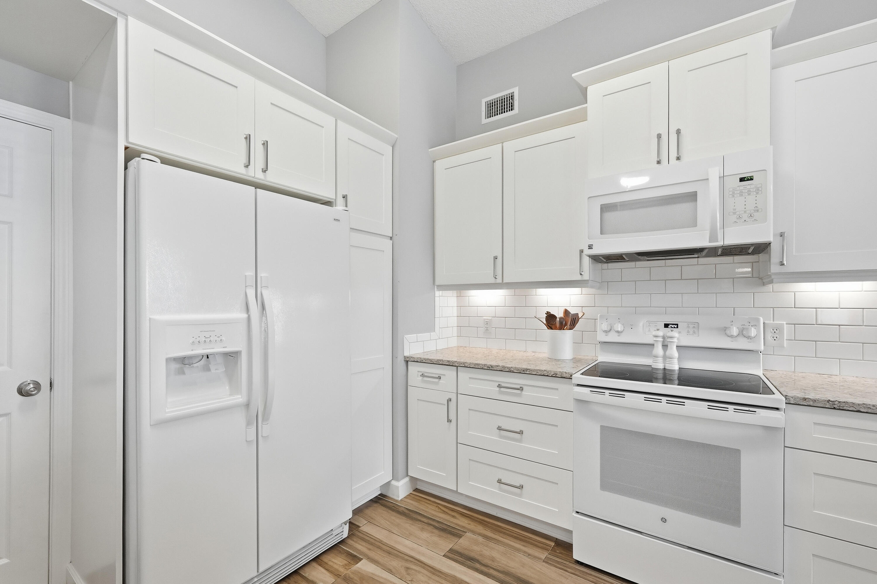 766 Randall Roberts Road Fort Walton Beach, FL 32547 - Photo 29 of 41 a kitchen with white cabinets and white appliances