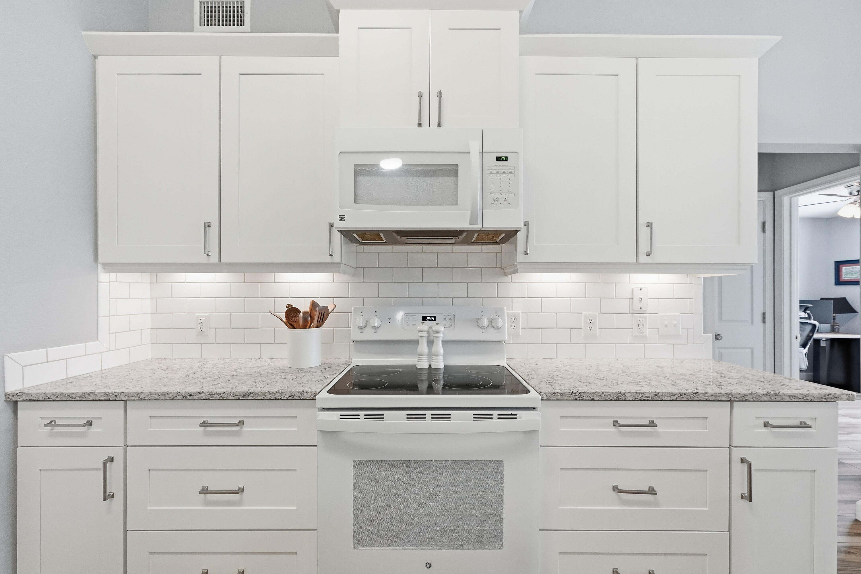766 Randall Roberts Road Fort Walton Beach, FL 32547 - Photo 30 of 41 a kitchen with granite countertop white cabinets and white appliances