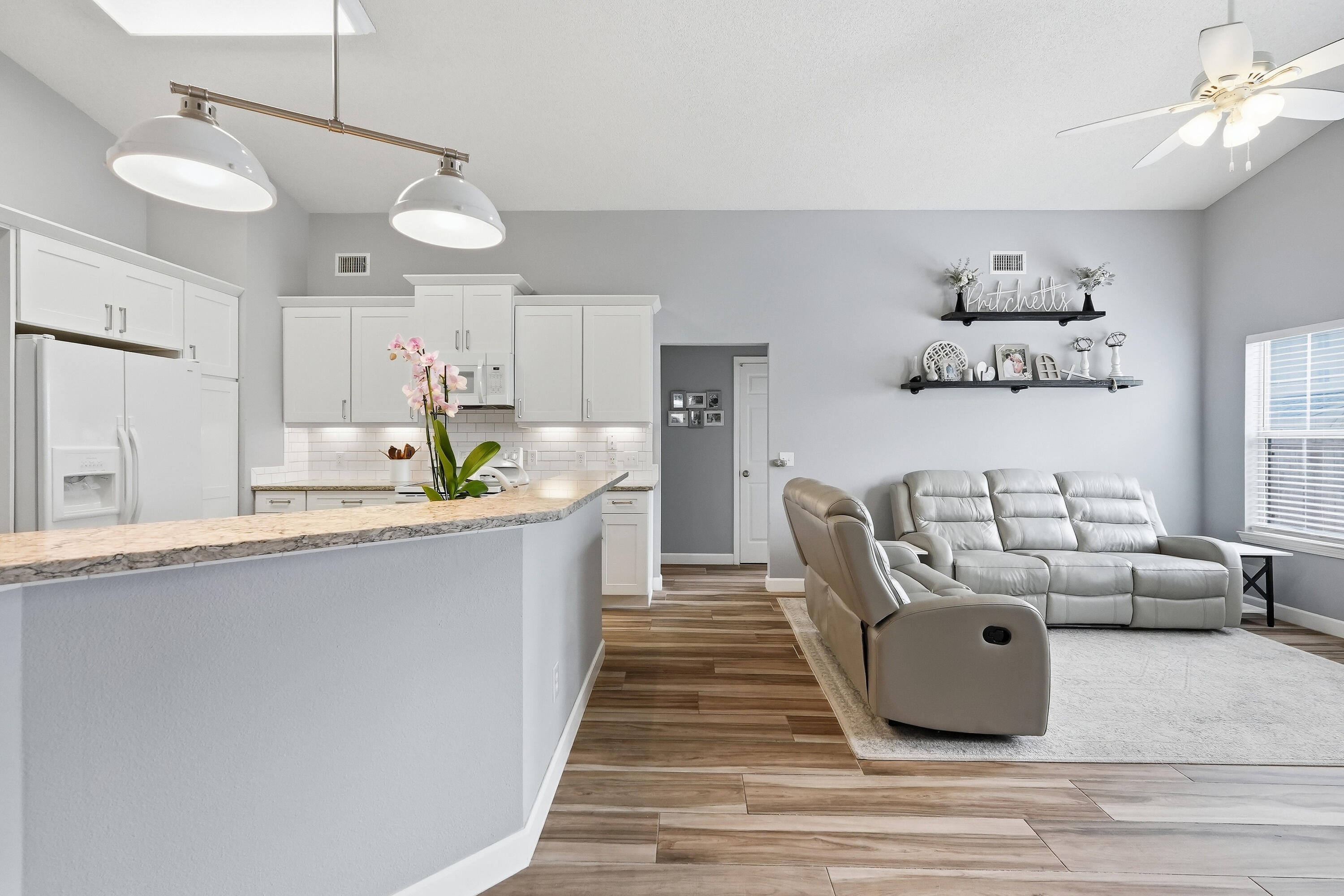 766 Randall Roberts Road Fort Walton Beach, FL 32547 - Photo 33 of 41 a large white kitchen with a white countertops a dining table and chairs