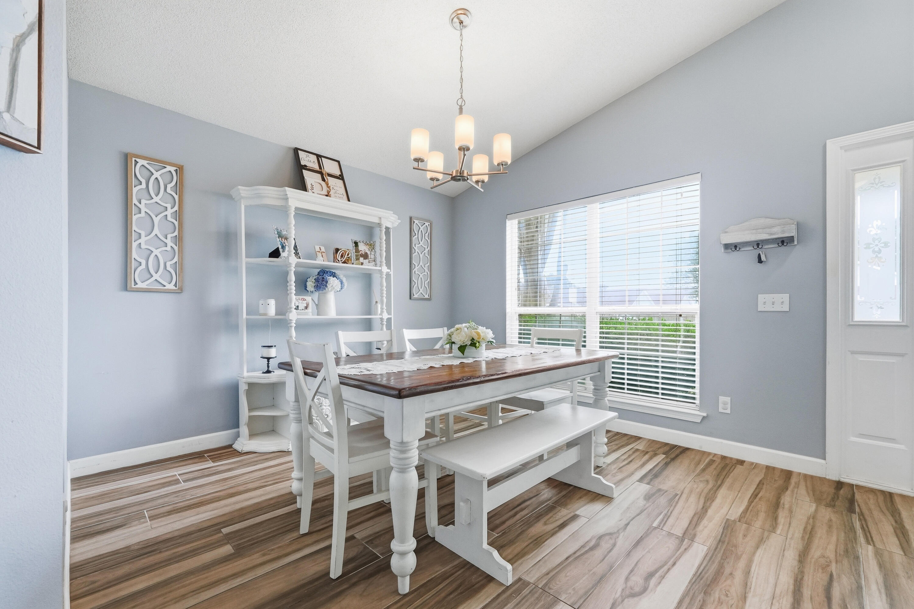 766 Randall Roberts Road Fort Walton Beach, FL 32547 - Photo 6 of 41 a dining room with wooden floor a chandelier a wooden table and chairs