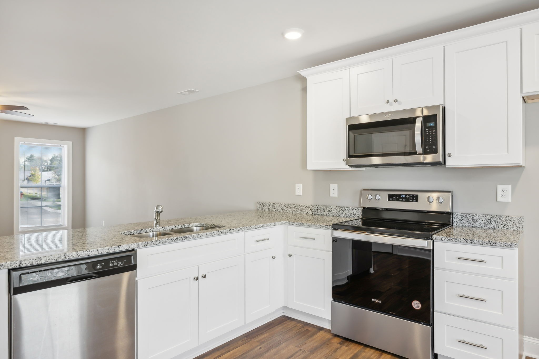 927 Sutton Cove Columbia, TN 38401 - Photo 14 of 24 a kitchen with granite countertop white cabinets white stainless steel appliances and a sink