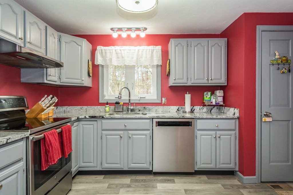 148 Walker Road Shirley, MA 01464 - Photo 11 of 35 a kitchen with granite countertop a sink stove top oven and cabinets