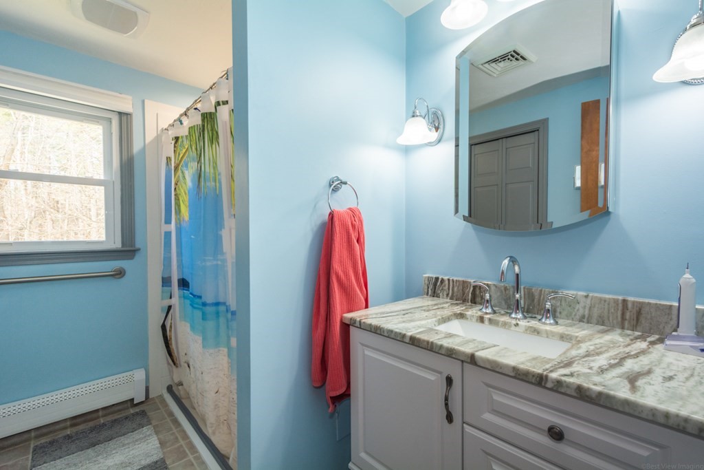 148 Walker Road Shirley, MA 01464 - Photo 19 of 35 a bathroom with a granite countertop sink and a mirror