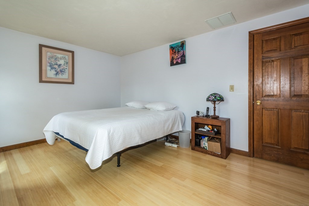 148 Walker Road Shirley, MA 01464 - Photo 21 of 35 a bedroom with a bed and wooden floor