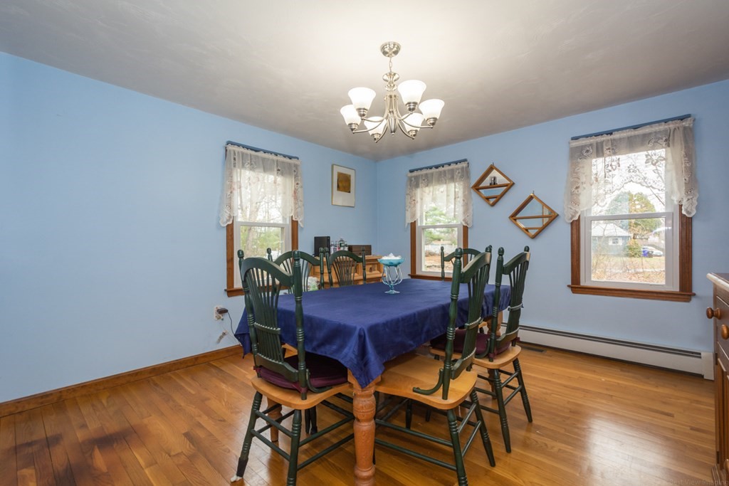 148 Walker Road Shirley, MA 01464 - Photo 5 of 35 a view of a dining room with furniture a chandelier and wooden floor