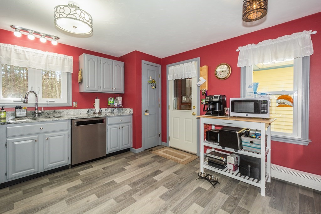 148 Walker Road Shirley, MA 01464 - Photo 7 of 35 a open kitchen with stainless steel appliances granite countertop a stove and a refrigerator