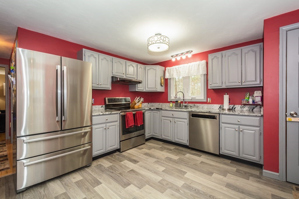148 Walker Road Shirley, MA 01464 - Photo 8 of 35 a kitchen with granite countertop stainless steel appliances and wooden cabinets