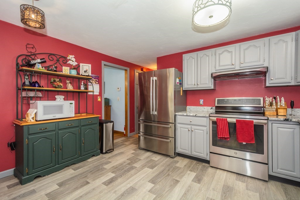 148 Walker Road Shirley, MA 01464 - Photo 9 of 35 a kitchen with stainless steel appliances granite countertop a refrigerator stove and sink