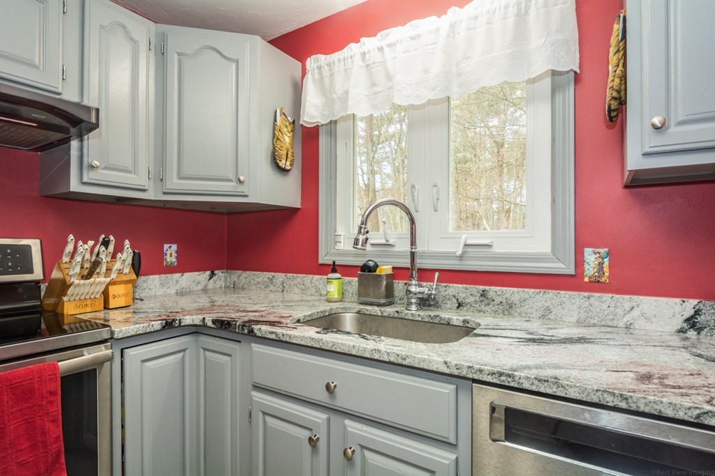 148 Walker Road Shirley, MA 01464 - Photo 10 of 35 a kitchen with granite countertop a sink and a stove