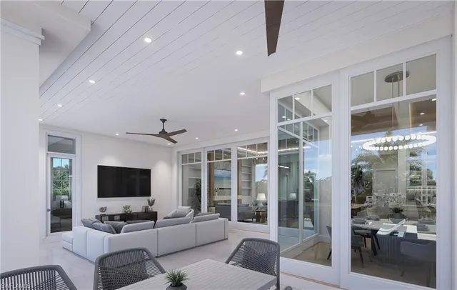 a living room with furniture a flat screen tv and a floor to ceiling window