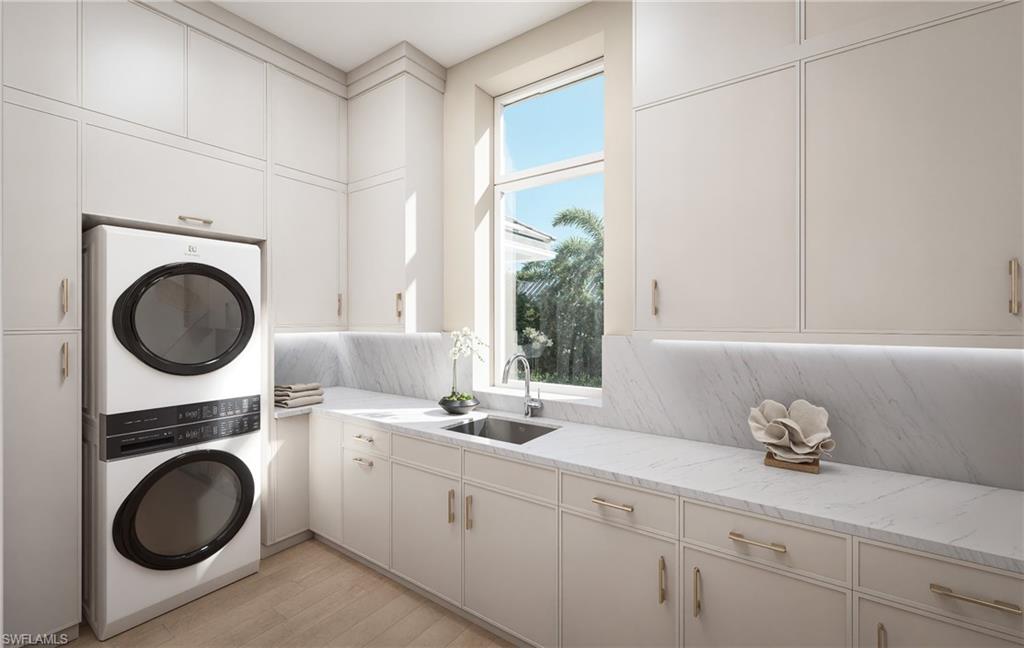 408 16th Avenue South Naples, FL 34102 - Photo 20 of 25 a kitchen with a sink a washer and dryer