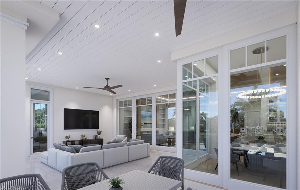 408 16th Avenue South Naples, FL 34102 - Photo 21 of 25 a living room with furniture a flat screen tv and a floor to ceiling window