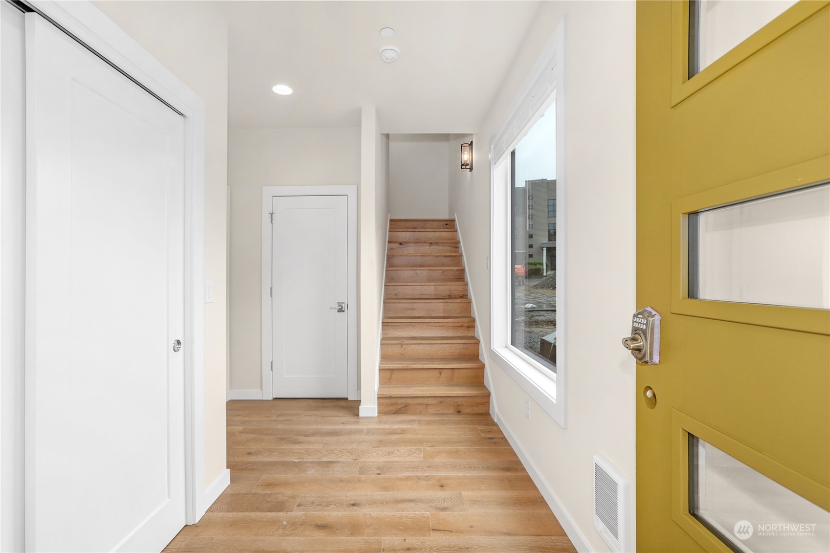 14493 Cedar Grove Road Southeast, Unit D102 Issaquah, WA 98027 - Photo 2 of 23 a view of a hallway with wooden floor and staircase