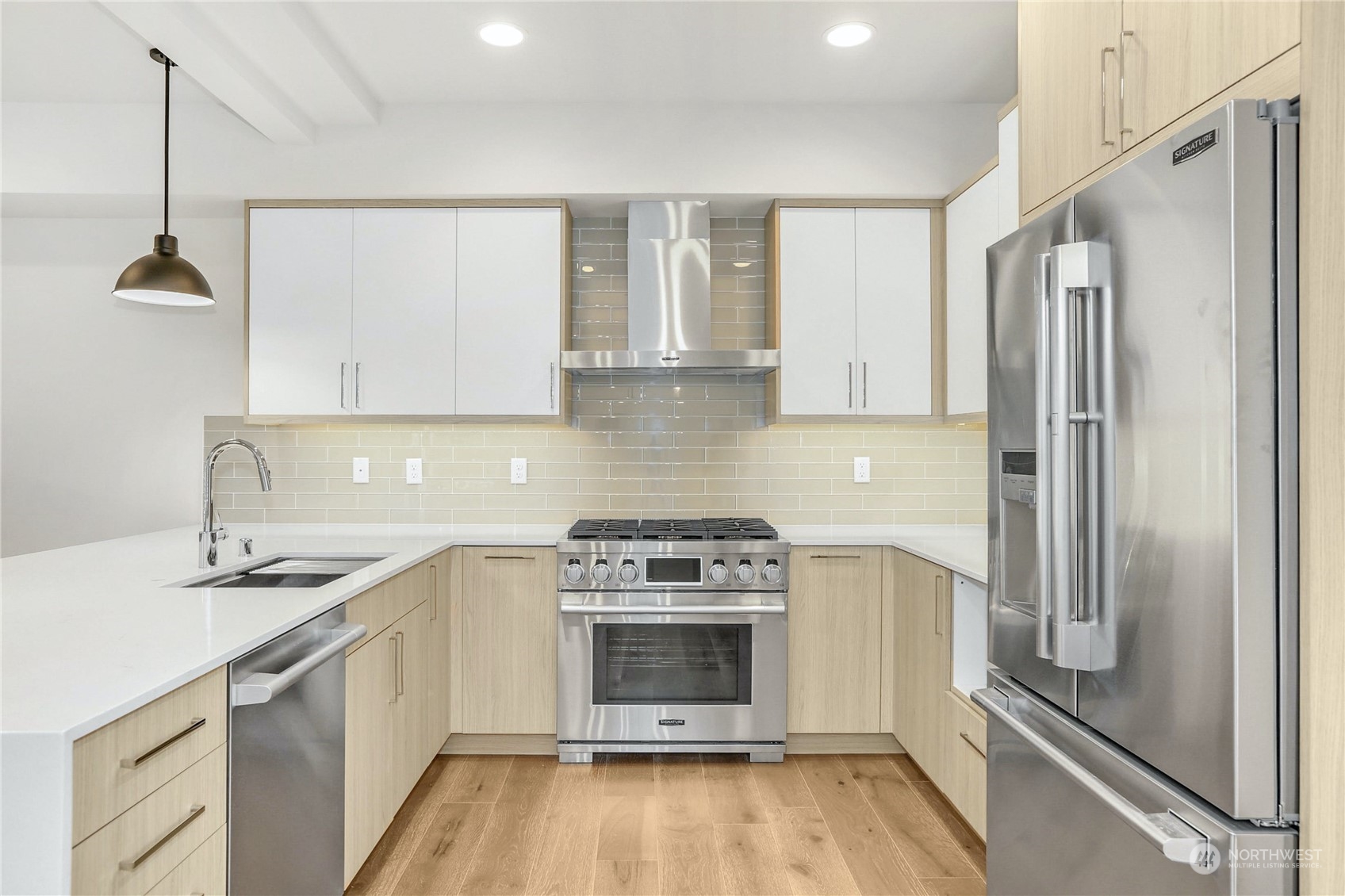 14493 Cedar Grove Road Southeast, Unit D102 Issaquah, WA 98027 - Photo 6 of 23 a kitchen with a stove a sink and a refrigerator