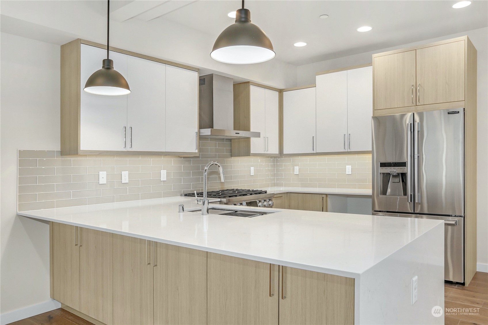 14493 Cedar Grove Road Southeast, Unit D102 Issaquah, WA 98027 - Photo 7 of 23 a kitchen with stainless steel appliances a sink stove and refrigerator