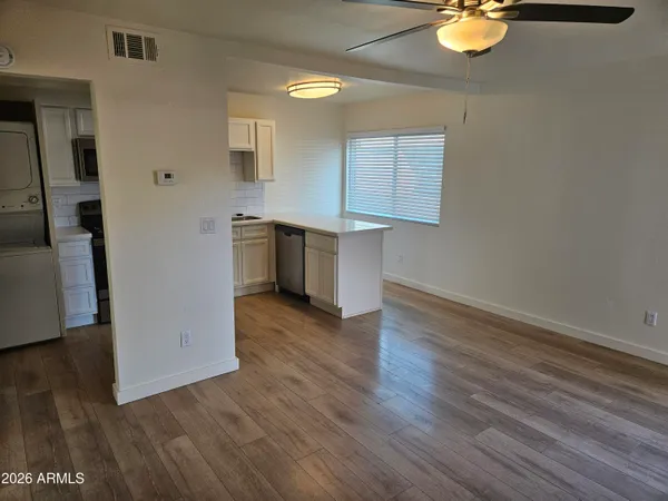 wooden floor in an empty room and a kitchen