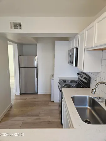 a kitchen with a sink stove and refrigerator