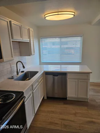 a kitchen with a stove and a sink