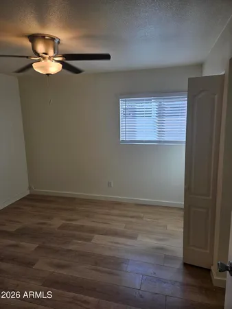 a view of an empty room with wooden floor