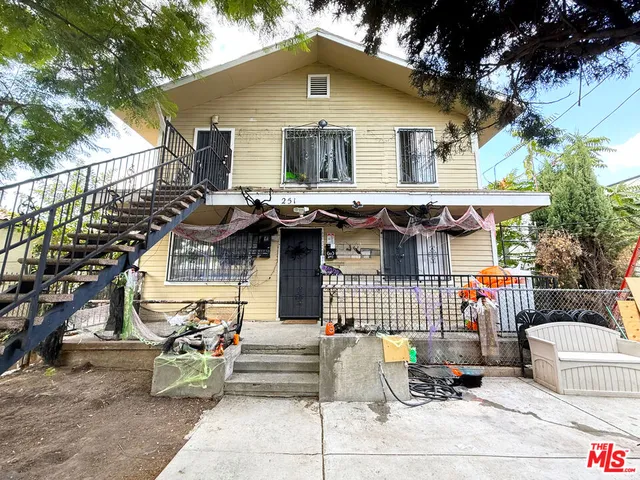 a front view of a house with outdoor seating