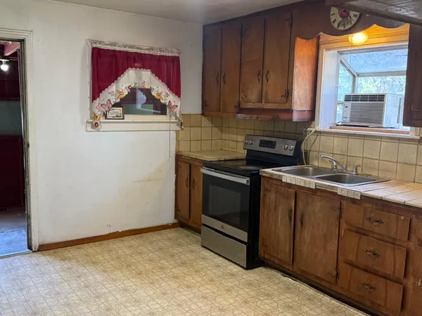 a view of a kitchen with a sink and cabinets