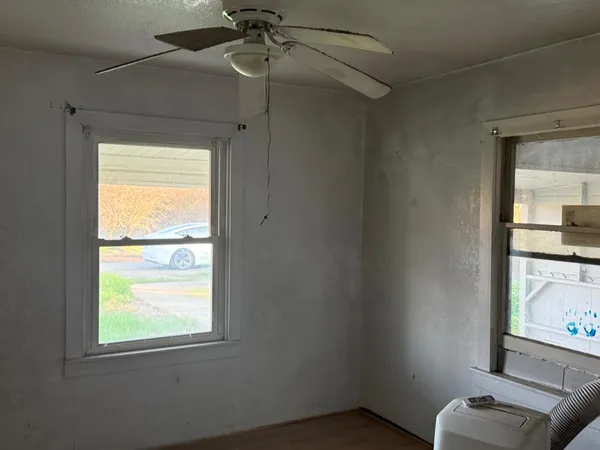 a view of room with window and a ceiling fan
