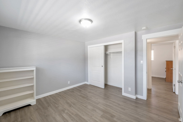 434 South 700 West, Unit 2 Provo, UT 84601 - Photo 14 of 15 Interior room featuring wood-finish flooring and a built-in closet with sliding doors