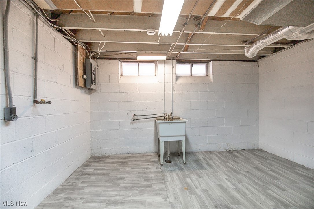 12328 Granger Road Cleveland, OH 44125 - Photo 32 of 37 Below grade area featuring electric panel and wood finished floors