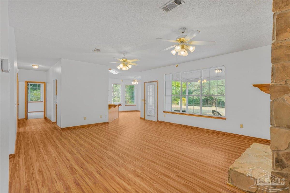 6500 Winston Brown Road Milton, FL 32570 - Photo 13 of 43 a view of an empty room with a window and wooden floor