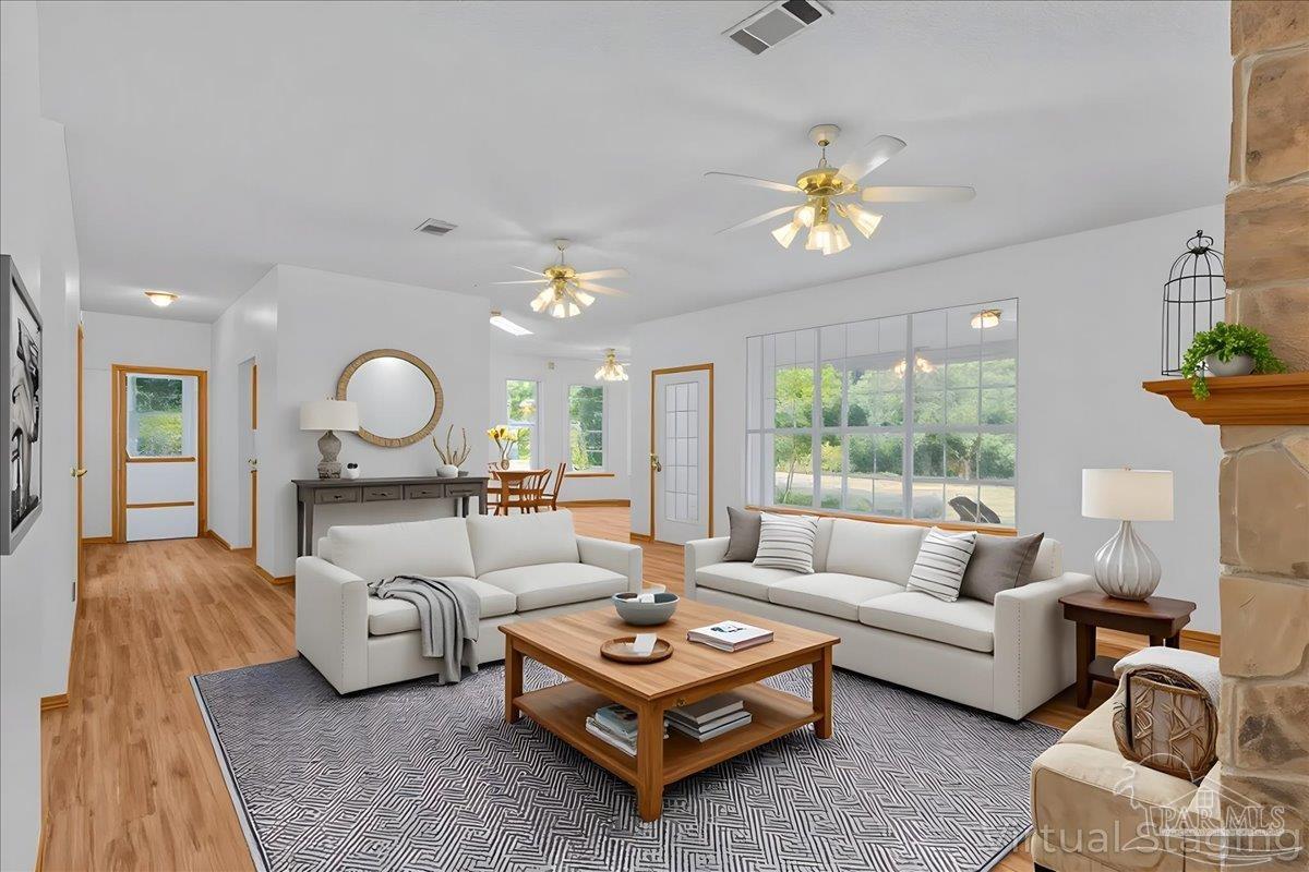6500 Winston Brown Road Milton, FL 32570 - Photo 14 of 43 a living room with furniture and a chandelier