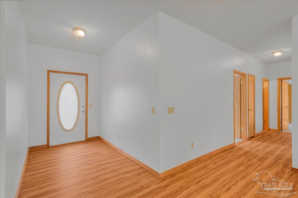 6500 Winston Brown Road Milton, FL 32570 - Photo 18 of 43 a view of a room with wooden floor and window