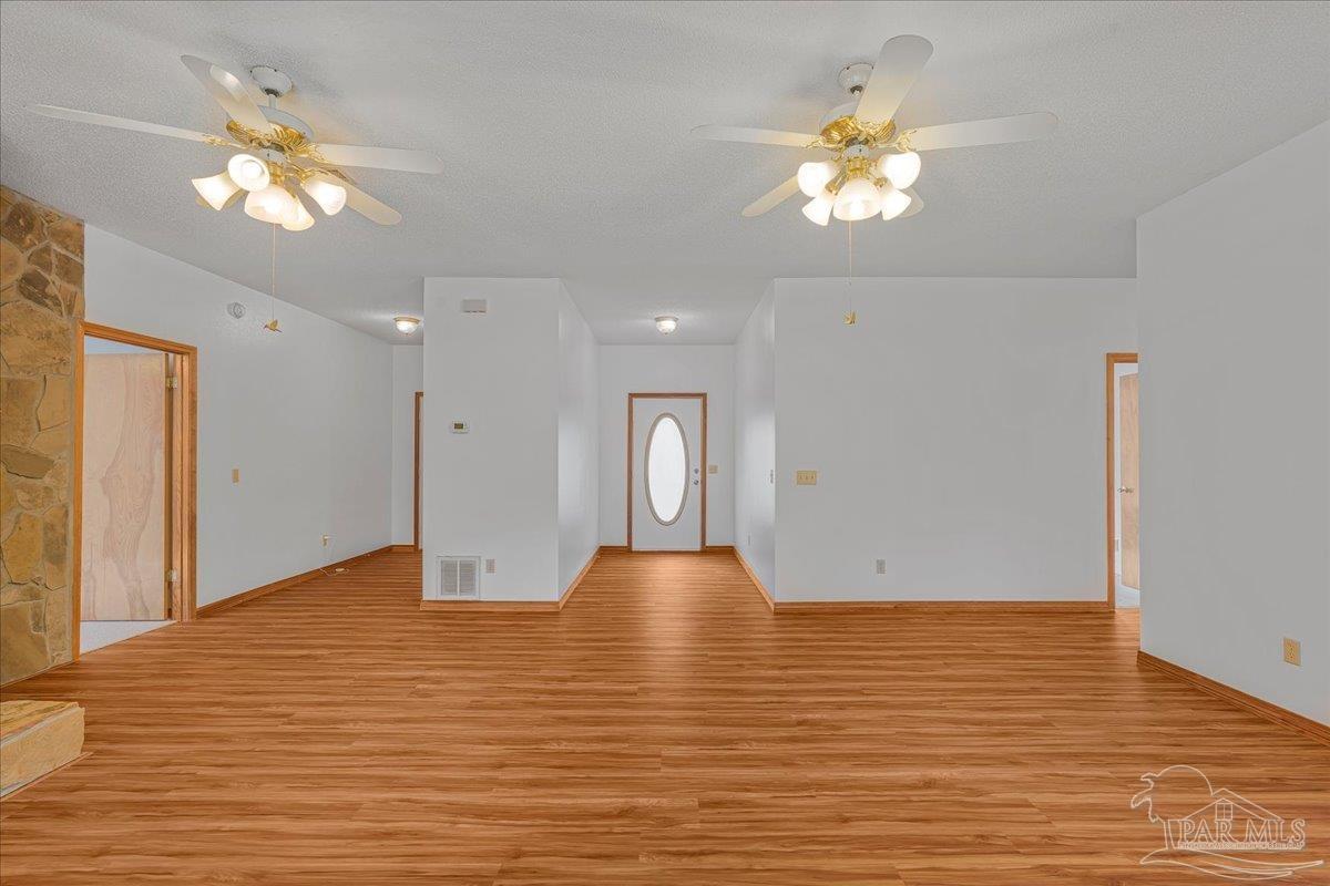 6500 Winston Brown Road Milton, FL 32570 - Photo 19 of 43 a view of empty room with wooden floor