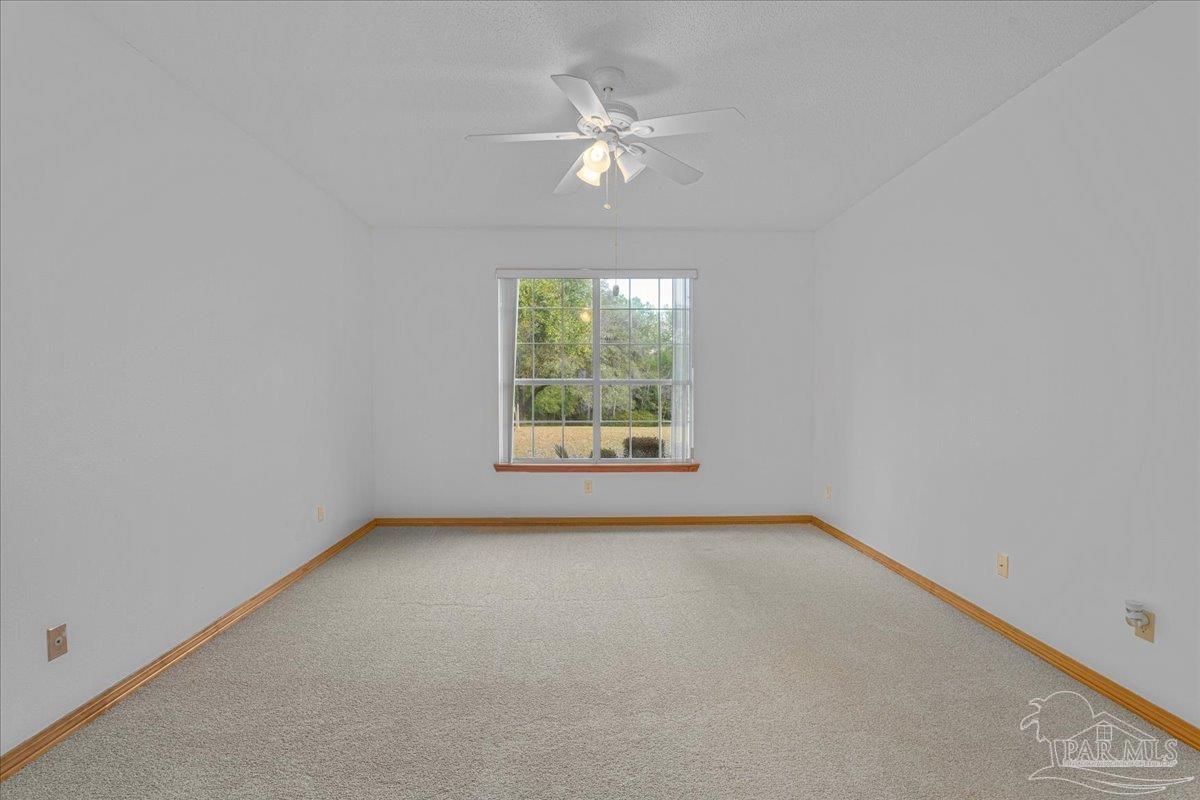 6500 Winston Brown Road Milton, FL 32570 - Photo 23 of 43 an empty room with a window and a fan