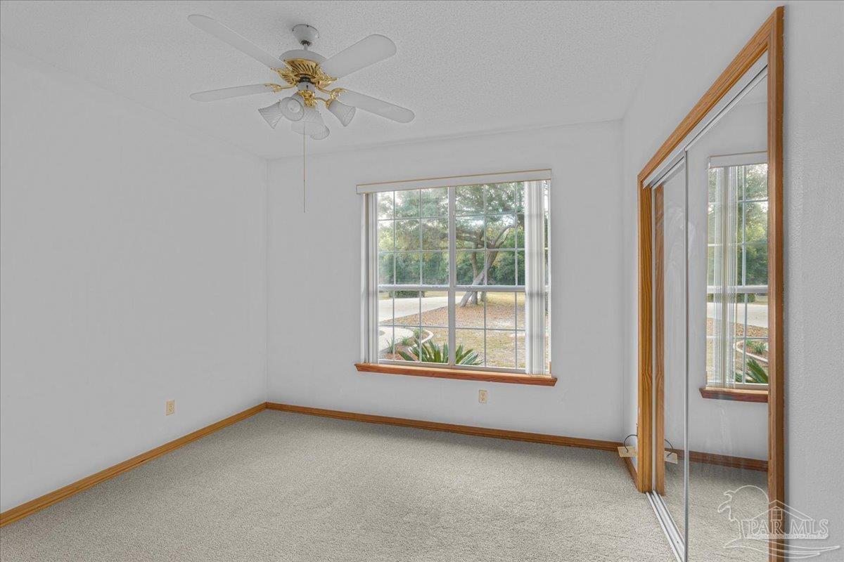 6500 Winston Brown Road Milton, FL 32570 - Photo 28 of 43 an empty room with fan and windows