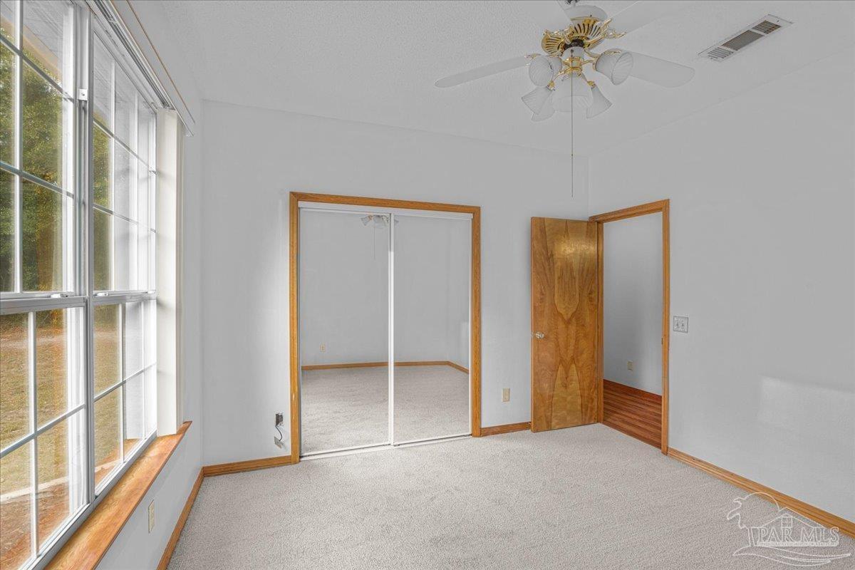 6500 Winston Brown Road Milton, FL 32570 - Photo 29 of 43 an empty room with windows