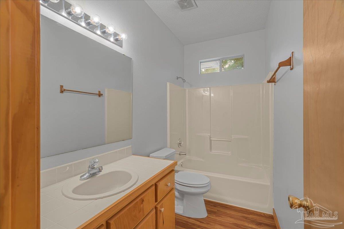 6500 Winston Brown Road Milton, FL 32570 - Photo 30 of 43 a bathroom with a granite countertop sink a toilet and shower