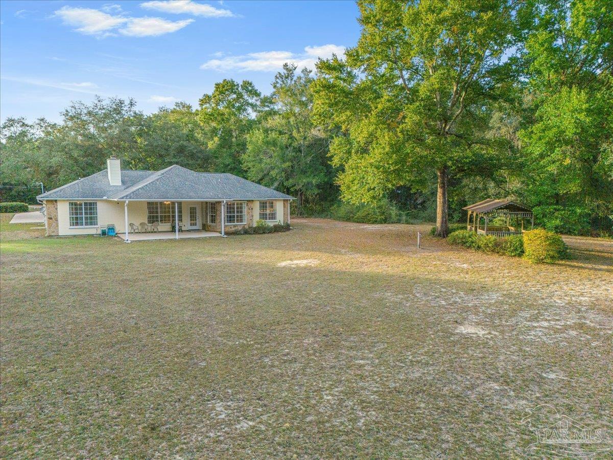 6500 Winston Brown Road Milton, FL 32570 - Photo 31 of 43 a view of a house with a yard and sitting area