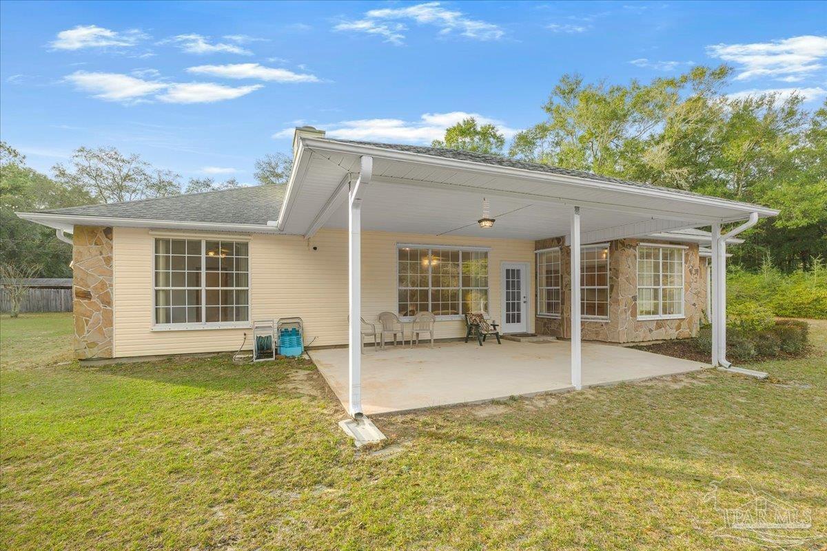 6500 Winston Brown Road Milton, FL 32570 - Photo 34 of 43 front view of a house with a swimming pool