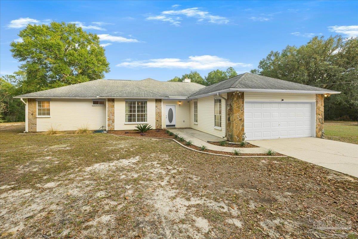 6500 Winston Brown Road Milton, FL 32570 - Photo 5 of 43 a front view of a house with a garden