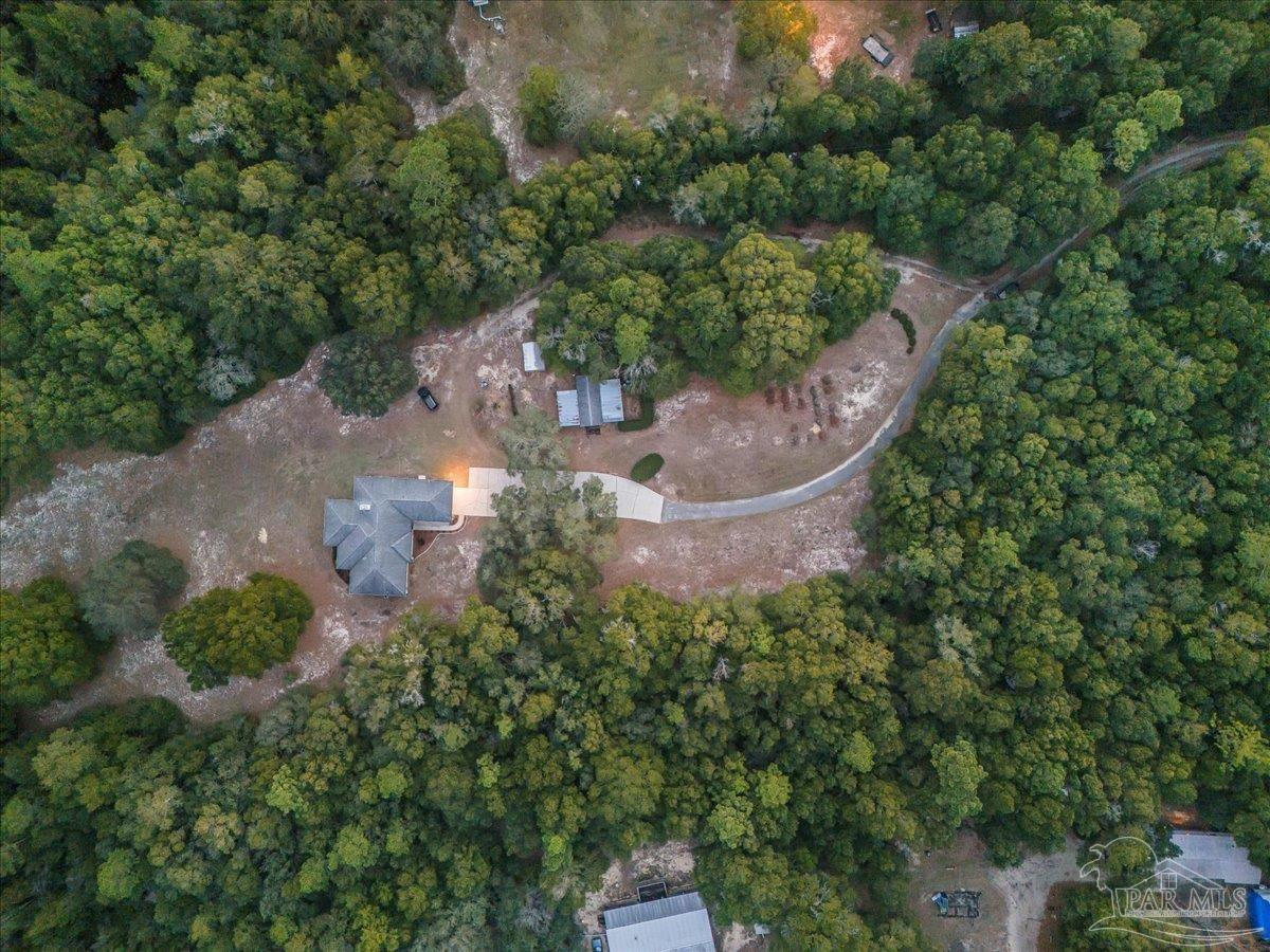 6500 Winston Brown Road Milton, FL 32570 - Photo 8 of 43 an aerial view of a house with a yard and outdoor seating