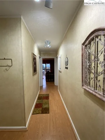 a bedroom with a bed and a flat tv screen on dresser