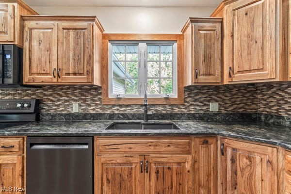 14413 Macklin Road New Springfield, OH 44443 - Photo 7 of 49 Kitchen featuring black appliances, tasteful backsplash, dark stone counters, and brown cabinetry