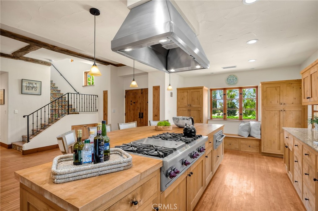 911 Laguna Road Fullerton, CA 92835 - Photo 27 of 68 a kitchen with stainless steel appliances granite countertop a stove and a wooden floors