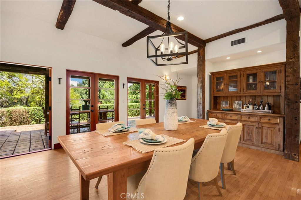 911 Laguna Road Fullerton, CA 92835 - Photo 38 of 68 a dining room with furniture a chandelier and wooden floor