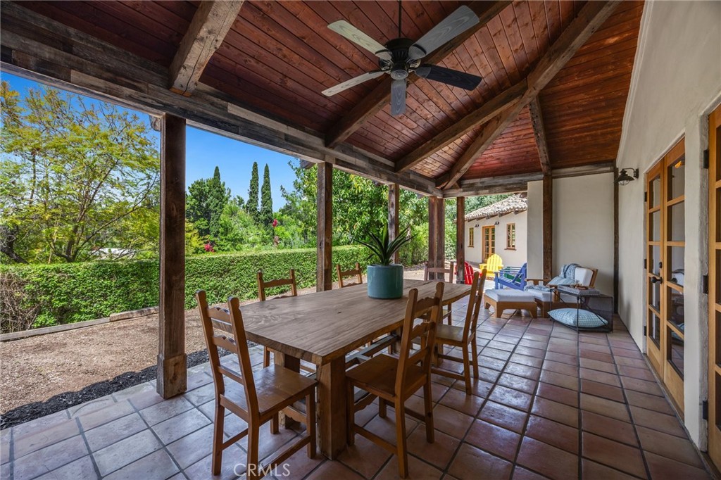 911 Laguna Road Fullerton, CA 92835 - Photo 40 of 68 a view of a patio with table and chairs and floor to ceiling window